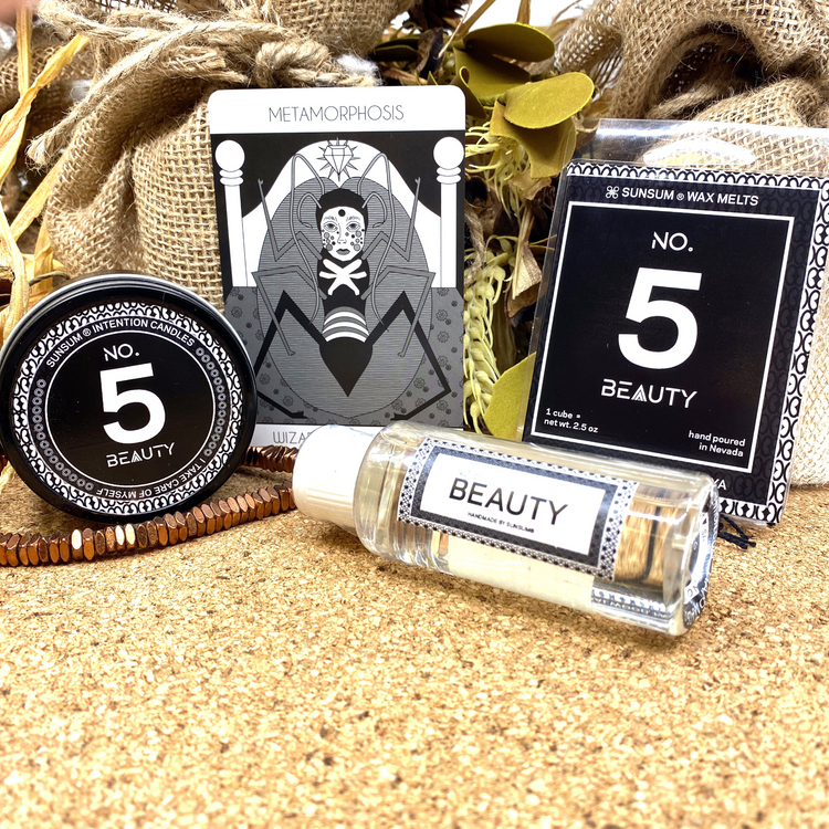 a group of beauty products on sand