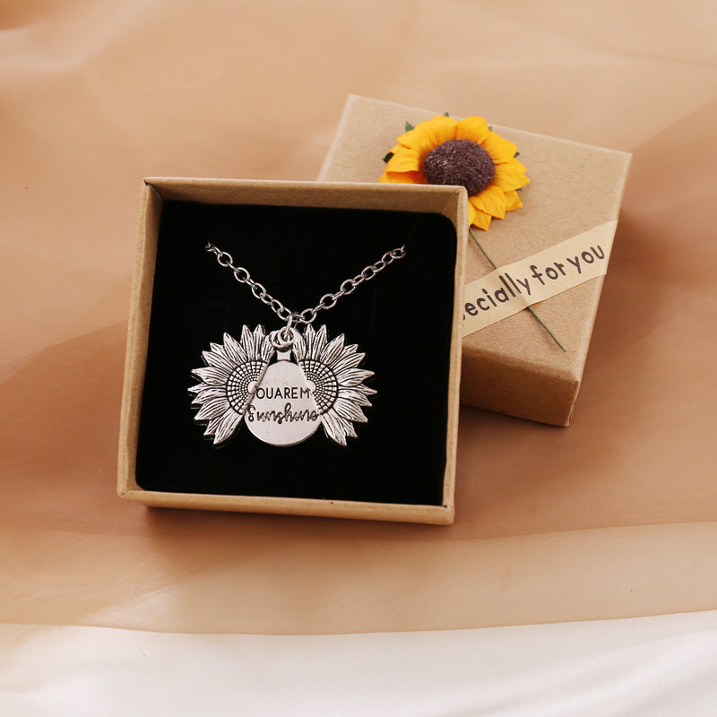 a necklace in a box with a sunflower