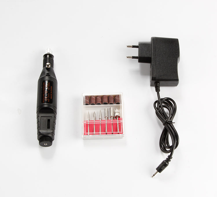a black electric drill and a box of bits