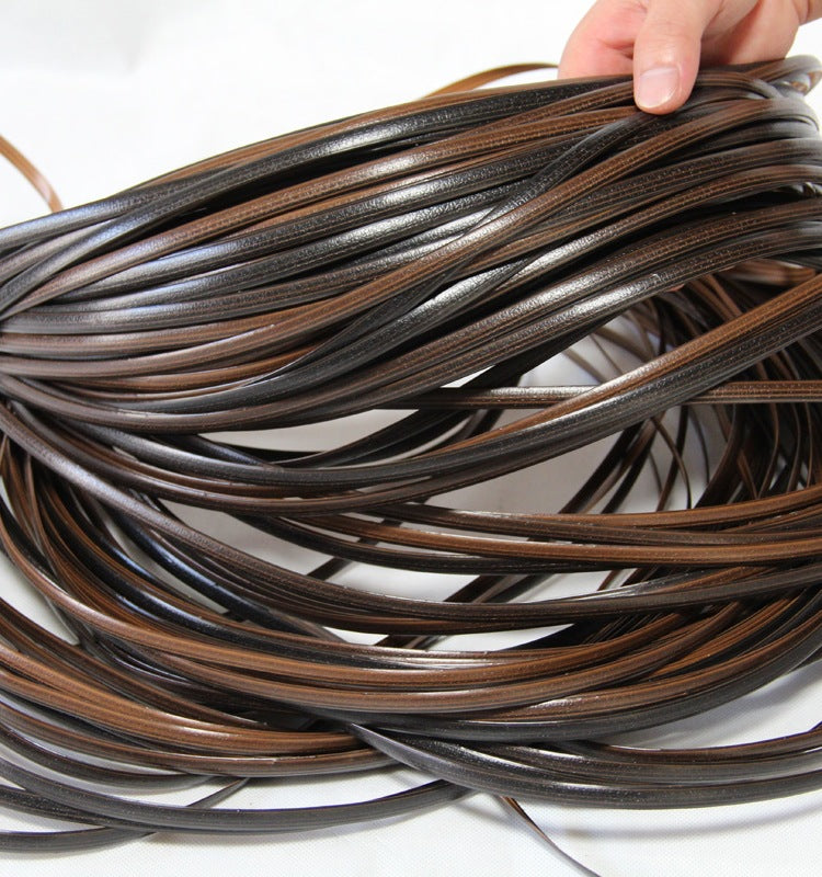 a hand holding a bundle of brown leather
