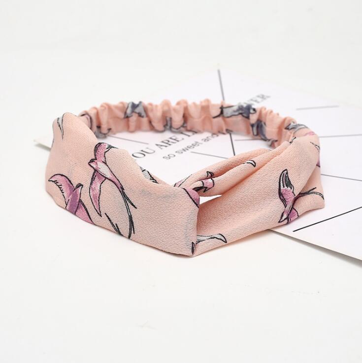 a pink headband with birds on it