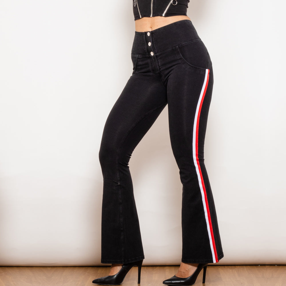 a woman wearing black pants and black heels
