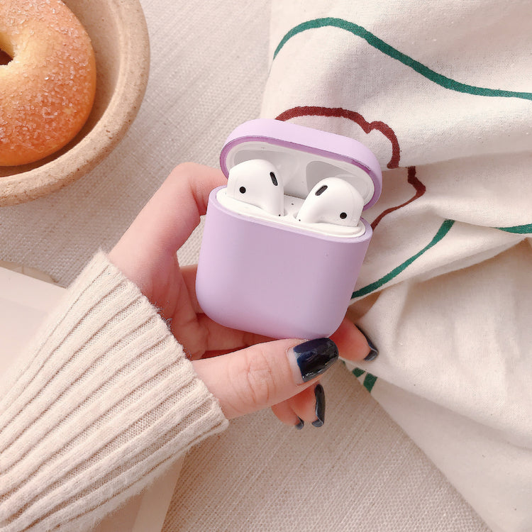 a hand holding a purple case with a donut in the background