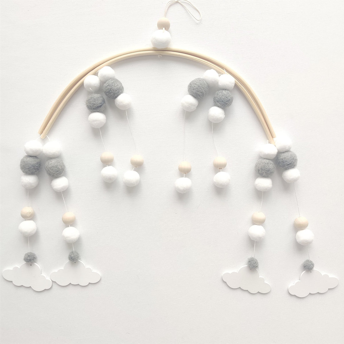 a mobile with pom poms and clouds