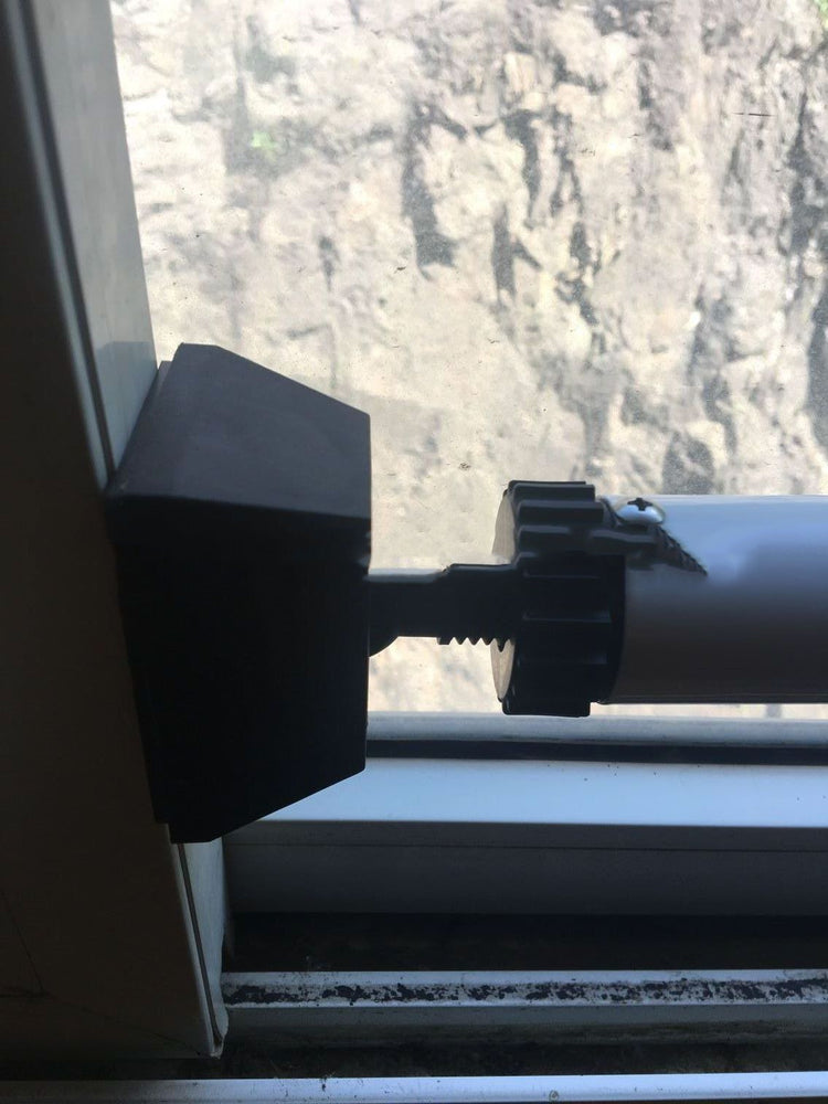 a black plastic object on a window