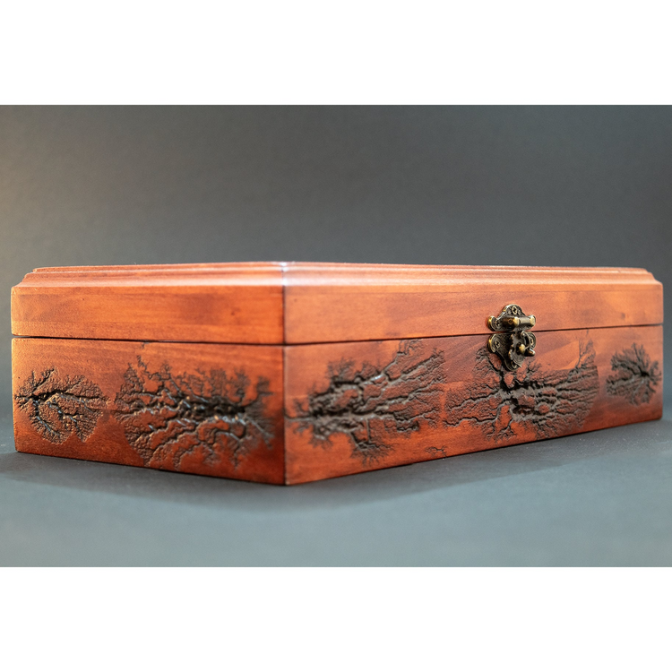 a wooden box with a tree design