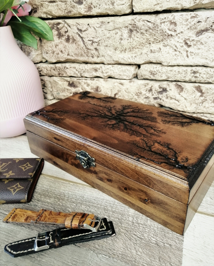 a wooden box with a lid and a wallet next to it