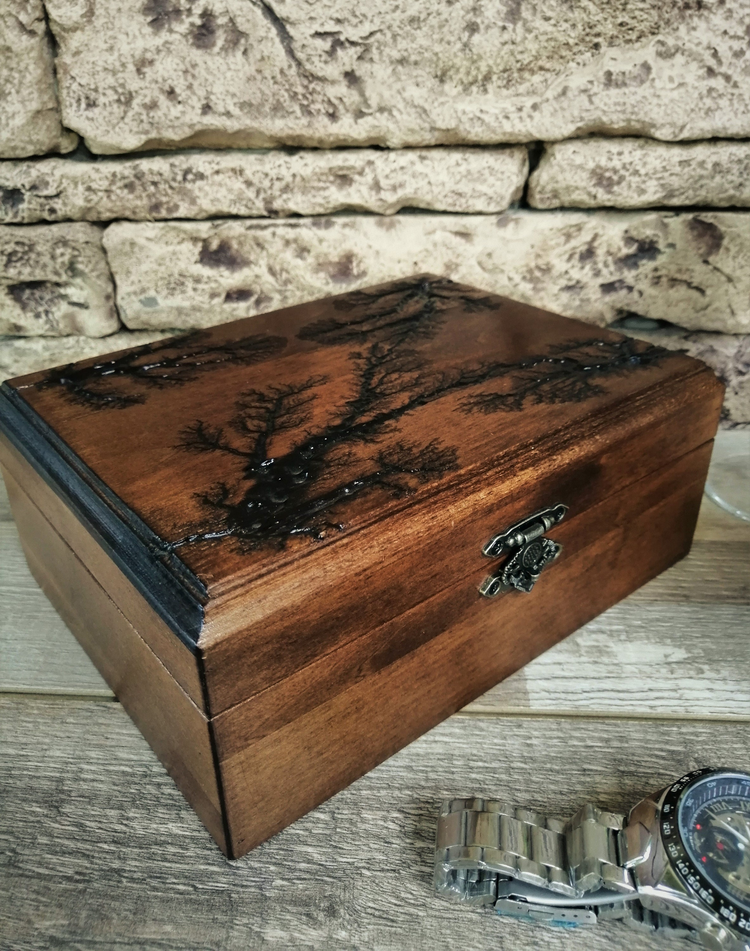 a wooden box with a watch on a table
