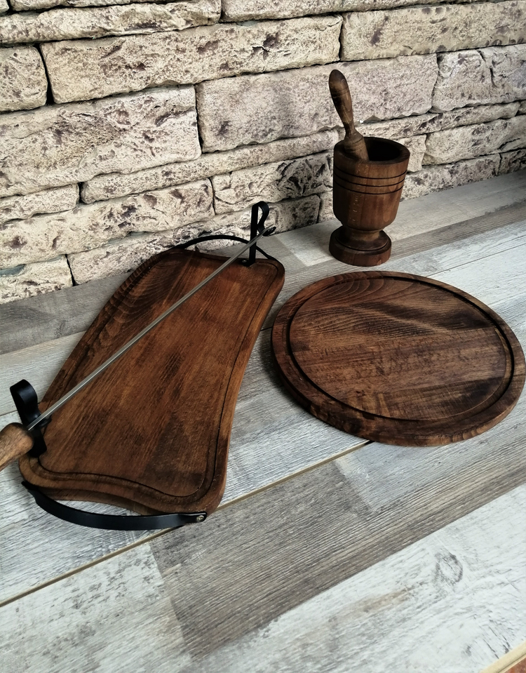a wooden cutting board and a mortar
