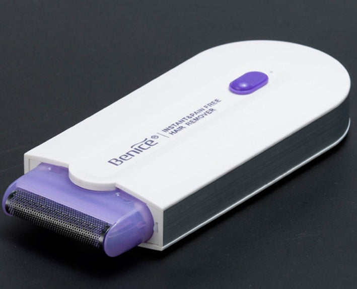 a hair removal device on a black surface