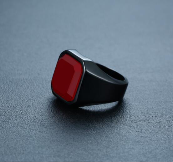 a black ring with a red square on it