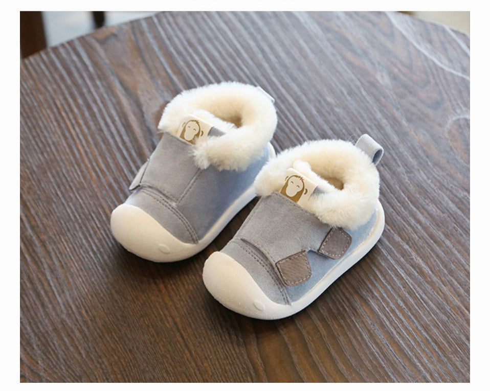 a pair of baby shoes on a table