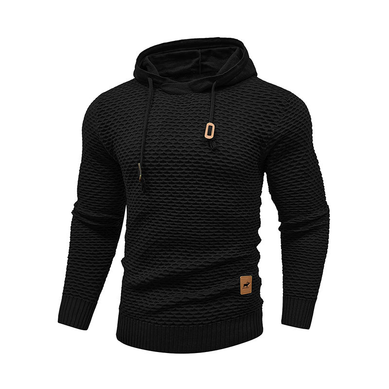 a black sweater with a gold tag