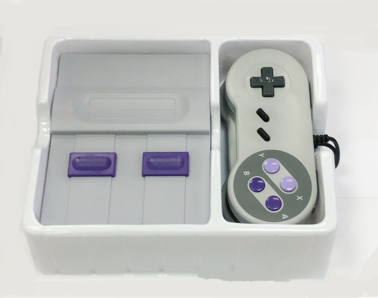 a white and purple video game controller in a white container