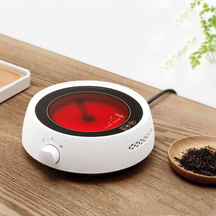 a white round device with a red screen on a wooden surface