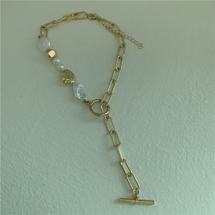 a gold chain with a toggle clasp