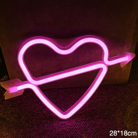 a pink neon heart with an arrow