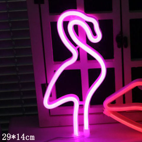 a pink flamingo shaped neon sign