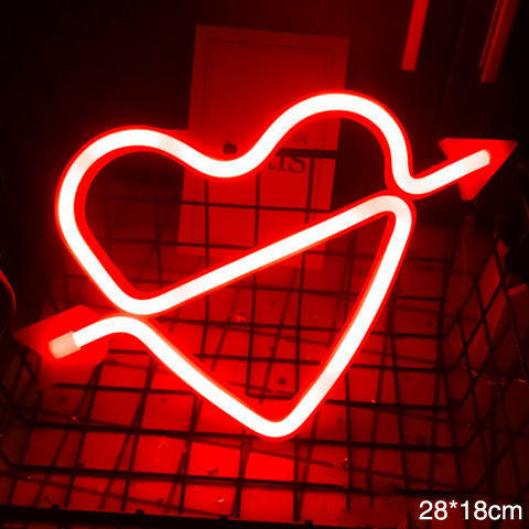 a red neon heart with an arrow