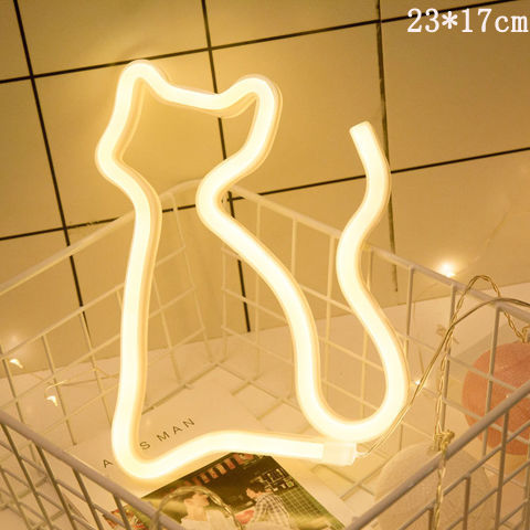 a cat shaped light in a wire basket
