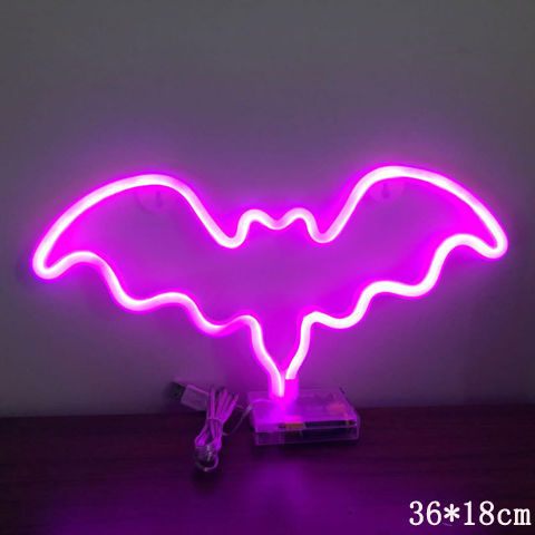 a purple neon bat shaped sign