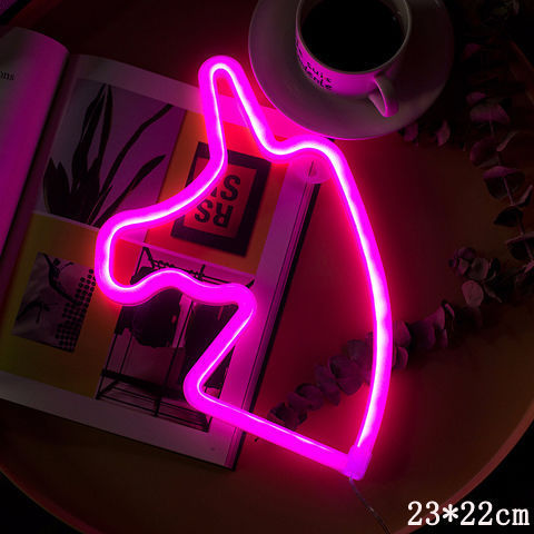 a pink neon sign on a plate
