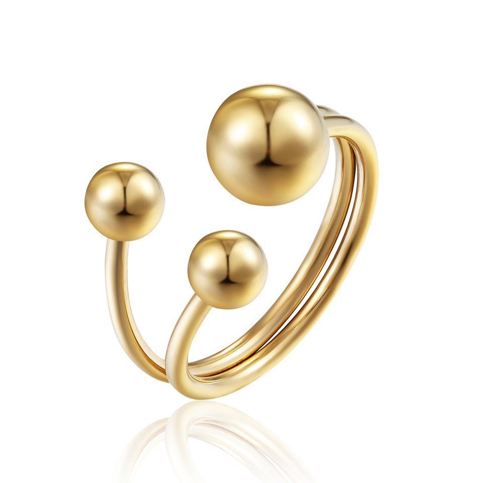 a gold ring with balls