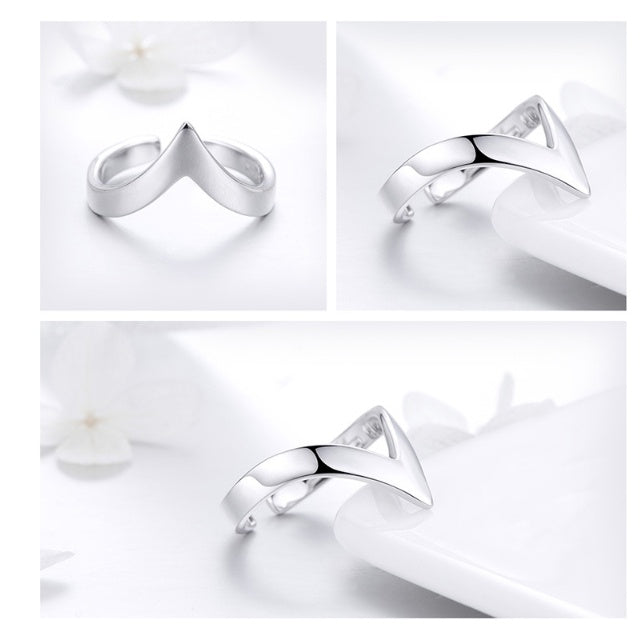 a silver ring on a white plate