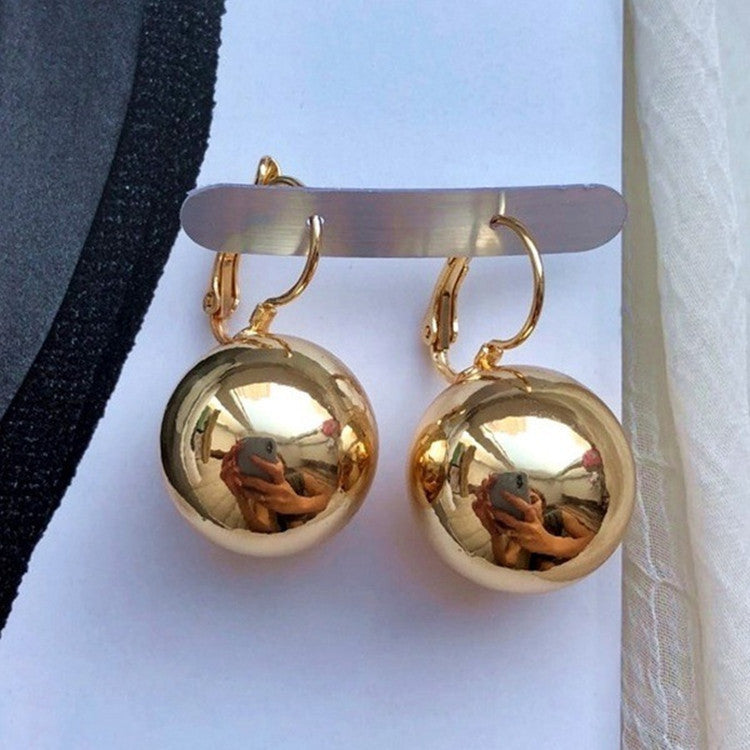 a pair of gold earrings