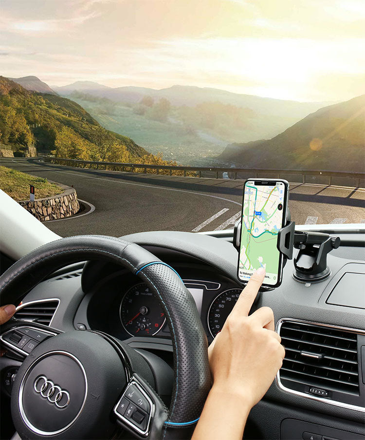 a person driving a car with a phone on the dashboard