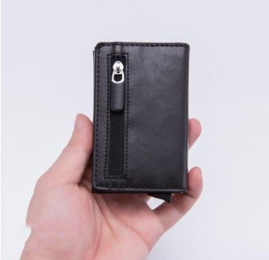 a hand holding a black wallet
