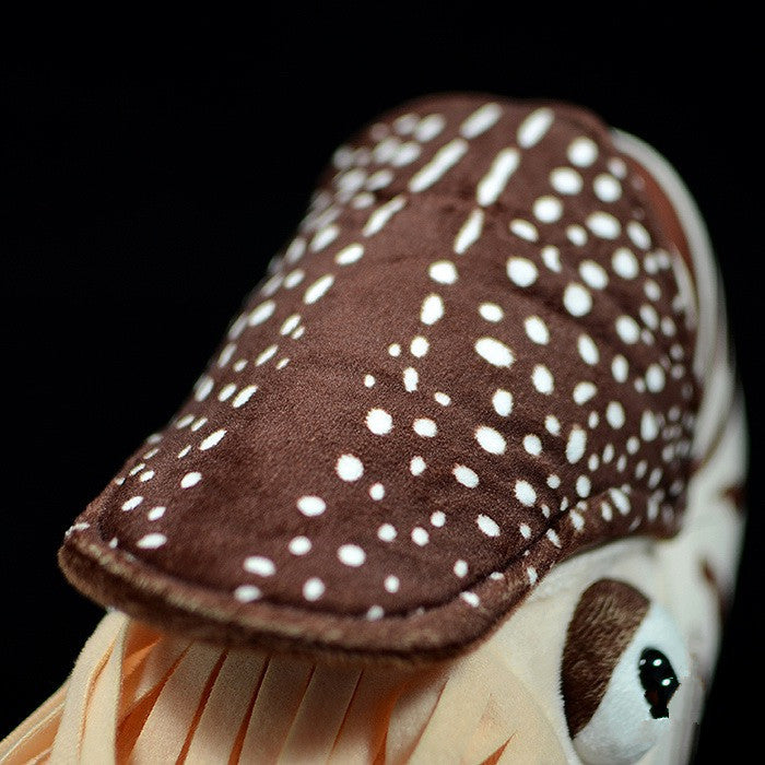 a stuffed animal with white dots