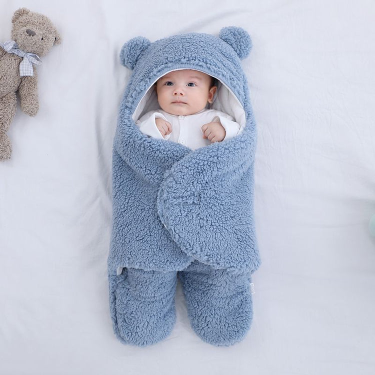 a baby wrapped in a blanket