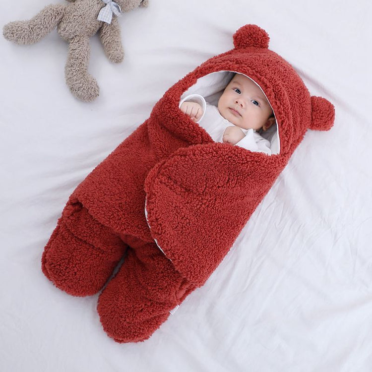 a baby wrapped in a blanket