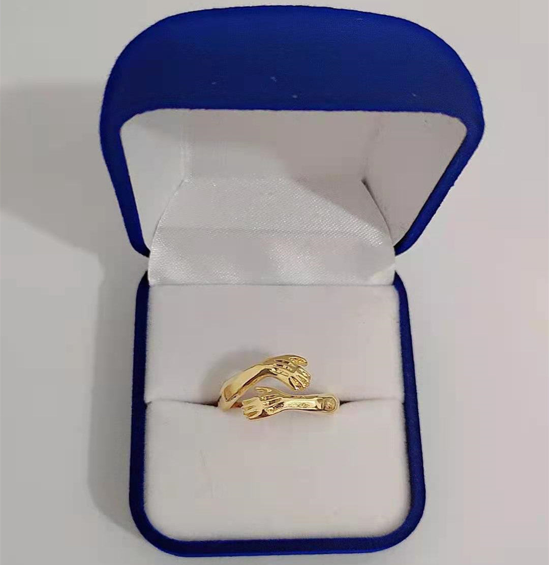 a gold ring in a box