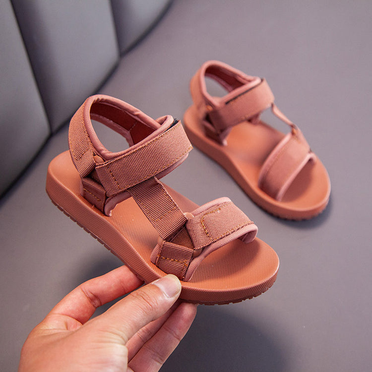 a person holding a pair of sandals