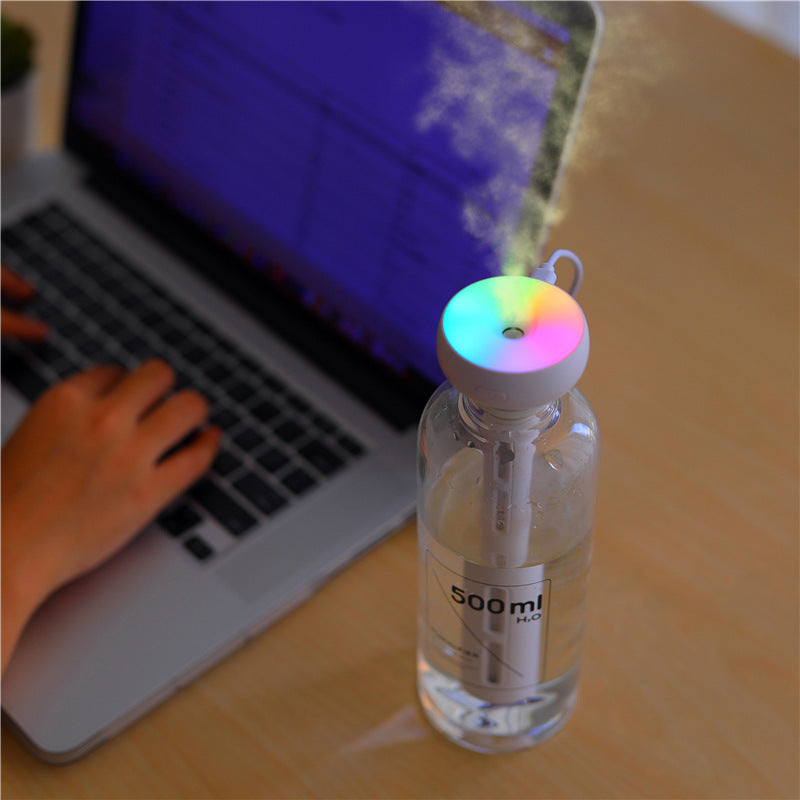 a water bottle with a colorful light coming out of it