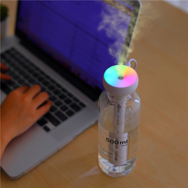 a water bottle with a colorful light coming out of it
