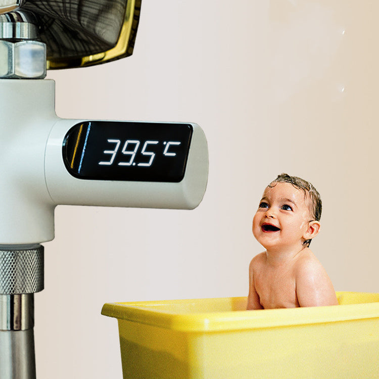 a baby in a tub with a temperature display