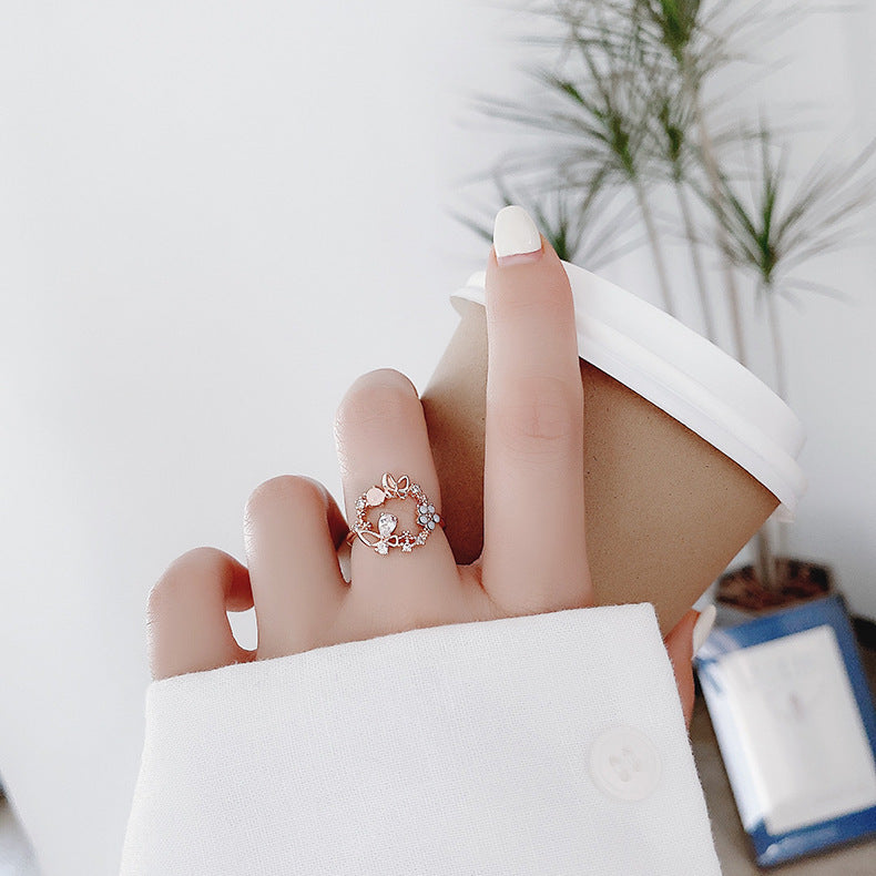 a hand with a ring on a cup of coffee