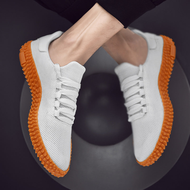a person's legs in white shoes with orange soles