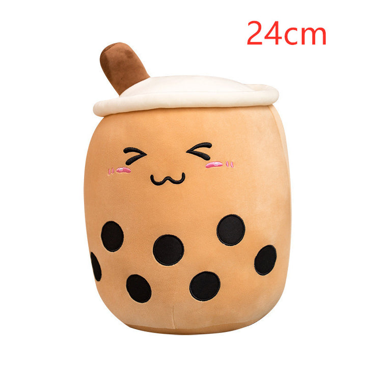 a brown and black plushie with a face