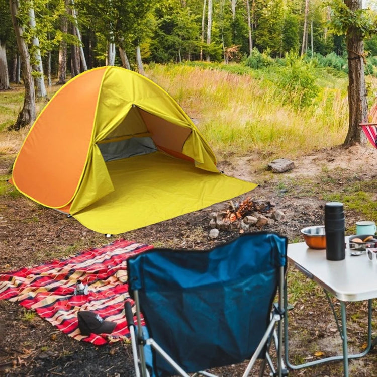 a tent and picnic table in a forest