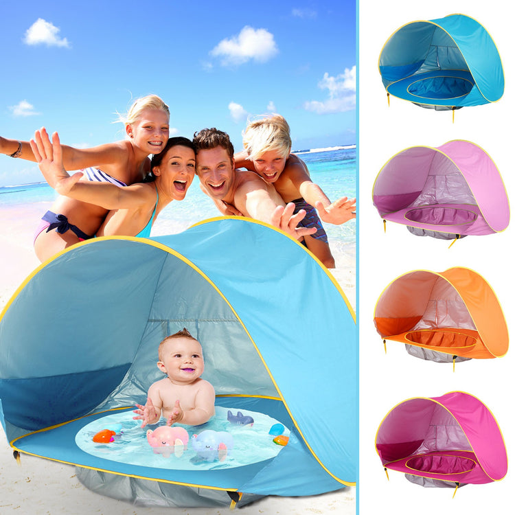 a group of people next to a baby in a tent