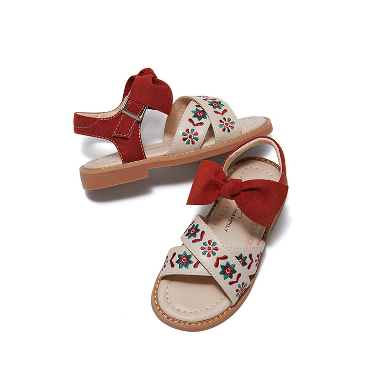 a pair of sandals with a bow
