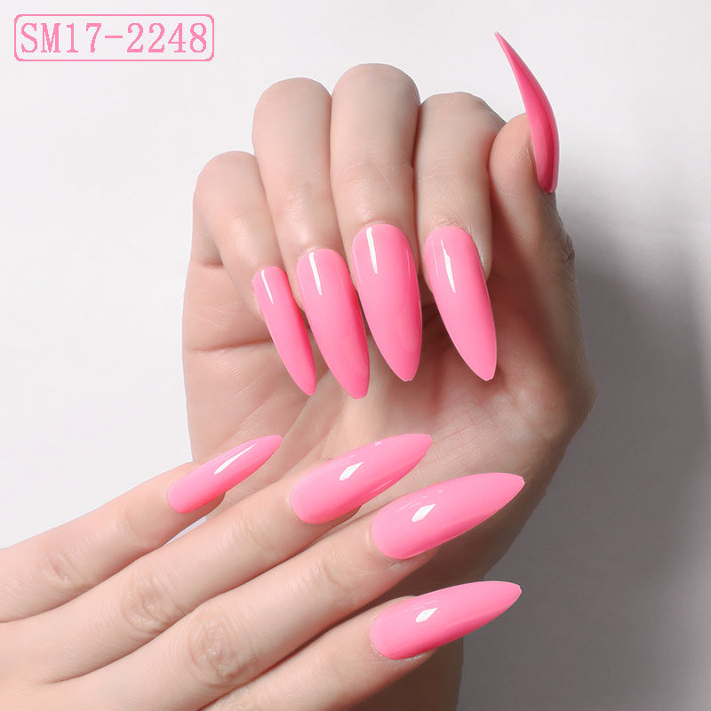 a hand with long pink nails