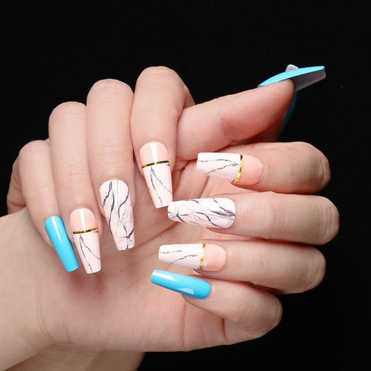a hand with long painted nails