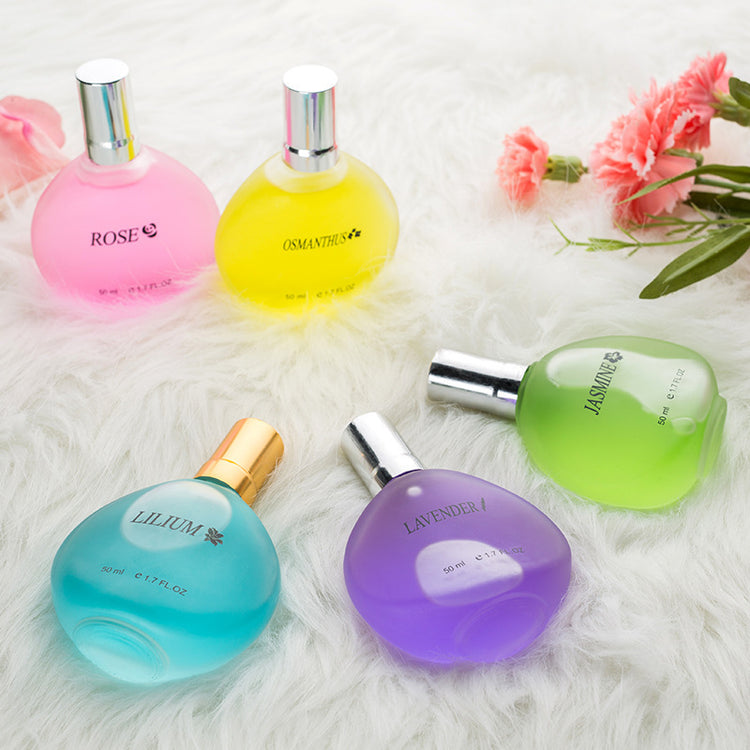 a group of perfume bottles on a white fur surface