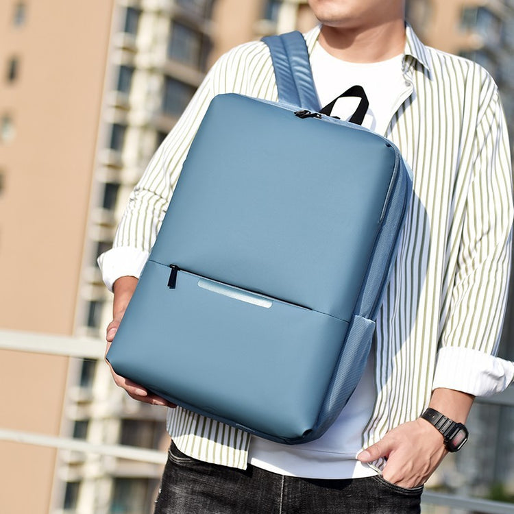 a man holding a blue bag