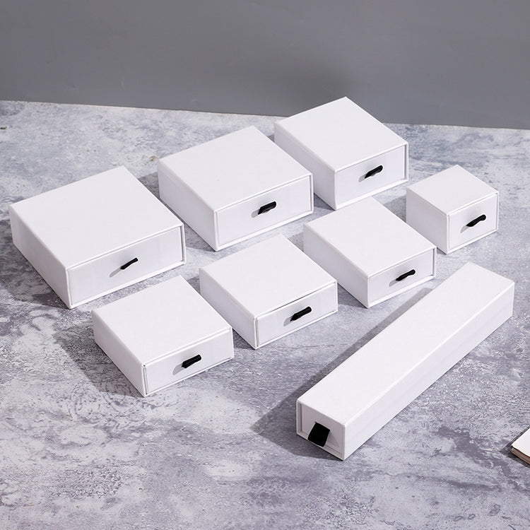 a group of white boxes with black handles